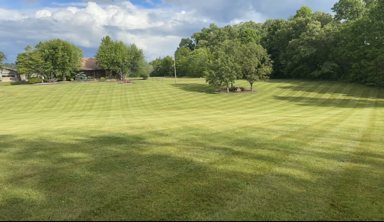 Wide manicured lawn near log cabin